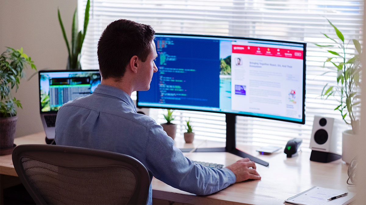 Remote office worker using a computer workstation for social distancing.